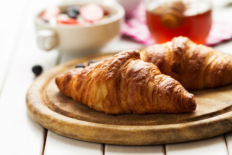 tasty-beautiful-croissants-wooden-board-traditional-continental-breakfast-granola-with-fruits-honey-background.jpg