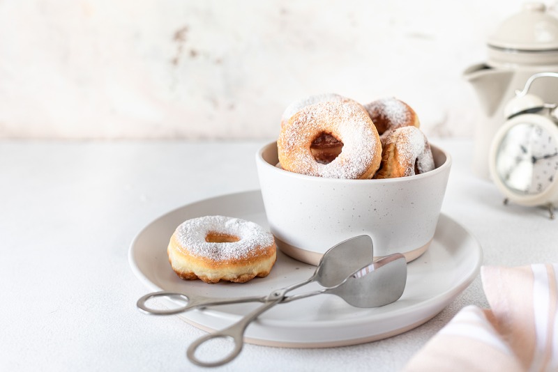 traditional-breakfast-doughnut-with-sugar-milk-coffee-white-background-selective-focus.jpg